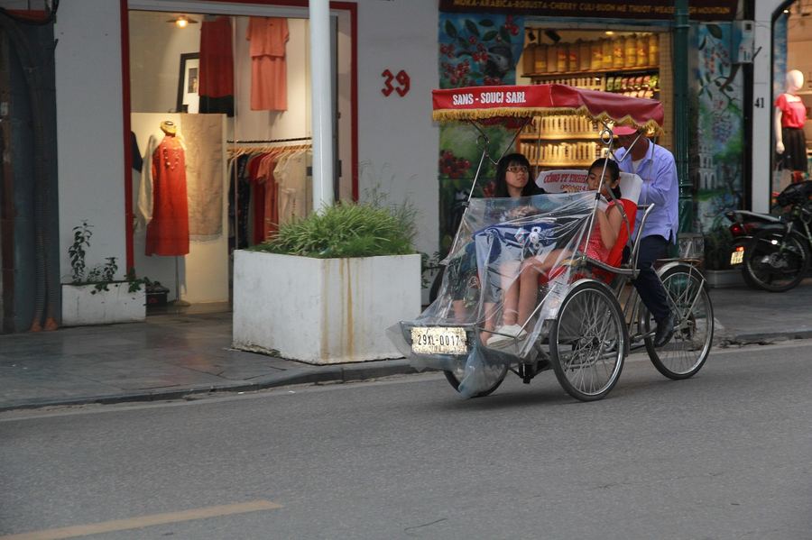 Cyclo bicycle taxi on a busy Vietnamese street